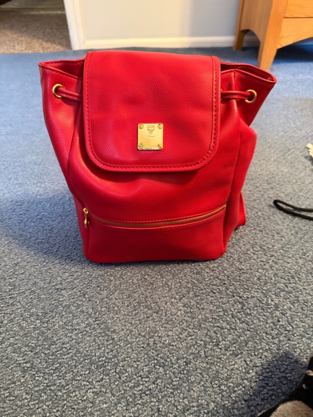 MCM Red Drawstring Backpack with Gold Plate